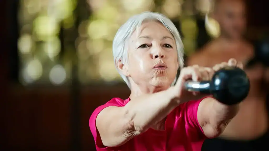 Toning Arms After 60: Empowering Womens Fitness Through Effective Weight Training 1 Older woman doing weight training Scottish to help her strength and longevity